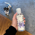 Hand holding Pawbright Dental Plus bottle with a small dog in the background